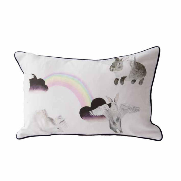 Flying bunnies animal print cushion by independent British brand Wild Hearts Wonder featuring clouds rainbows and flying bunnies on the front and animal spot print on the reverse