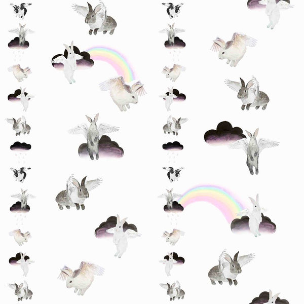 Flying bunnies animal print cushion by independent British brand Wild Hearts Wonder featuring clouds rainbows and flying bunnies on the front and animal spot print on the reverse