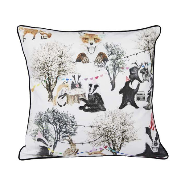 Woodland rave print cushion by independent British brand Wild Hearts Wonder featuring variety of woodland animals including foxes, badgers and bunnies on the front and animal spot print on the reverse